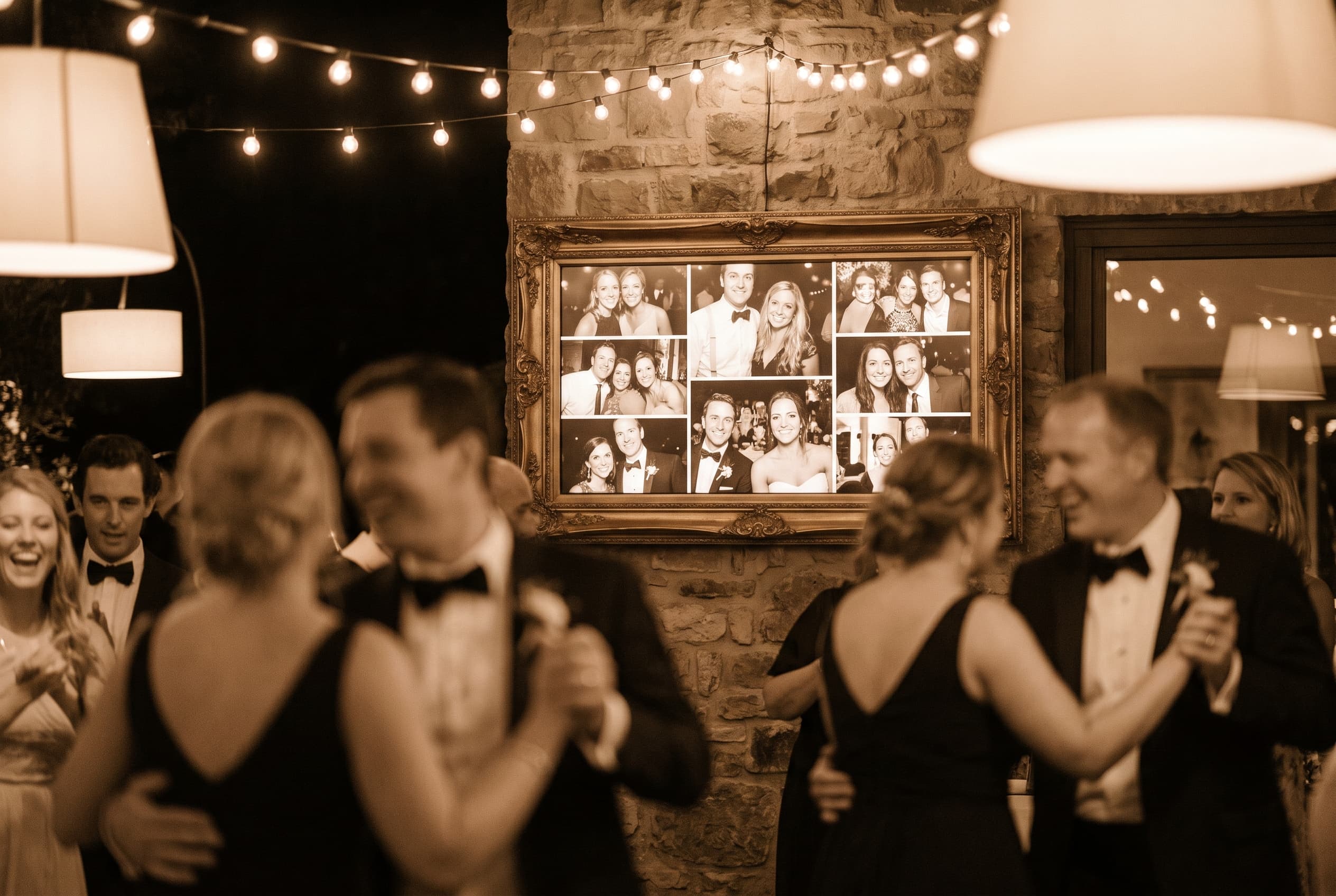 Écran encadré affichant une mosaïque de photos de mariage en direct pendant une soirée dansante, guirlandes lumineuses